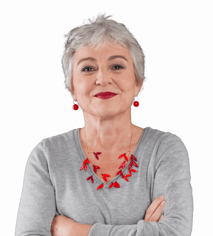 An older woman standing confidently with her arms folded