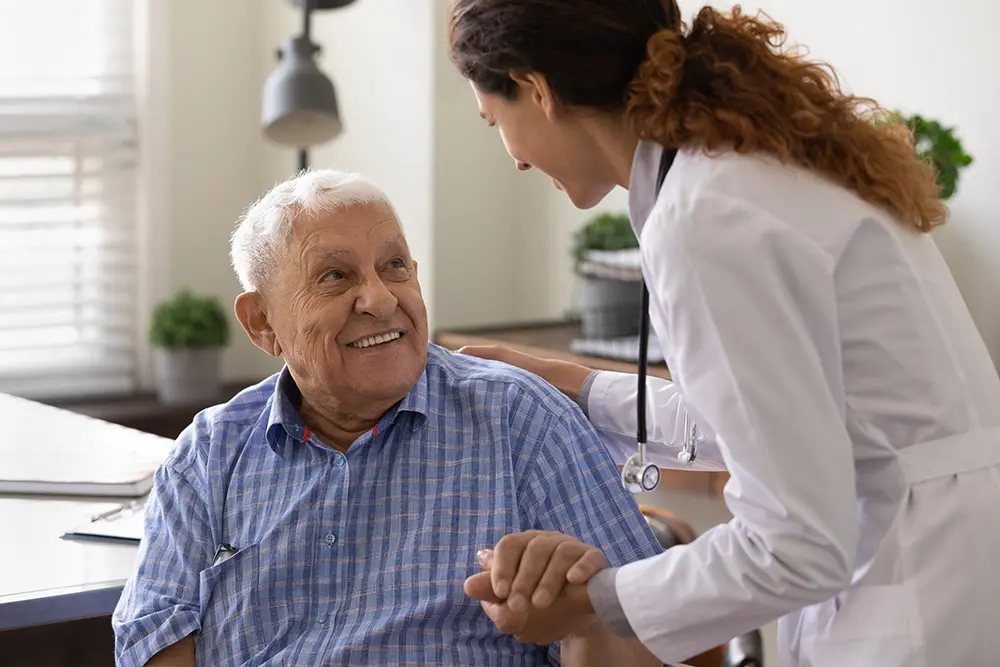 A clinician talks with an older man about changes in his memory